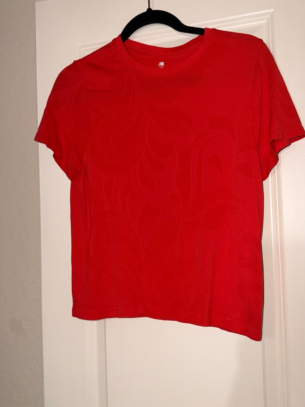 New Balance Red Short Sleeve Women's Tee with Subtle Pattern